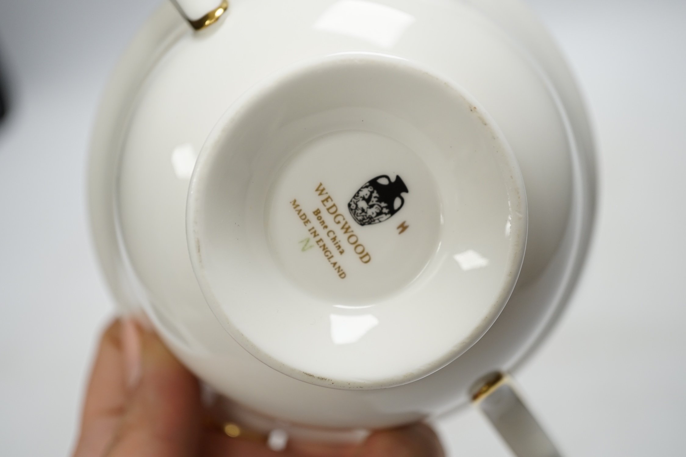 A Wedgwood bone china gold Florentine part dinner service, including an oval dish, twin handled cups and plates, largest 35cm wide